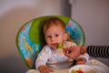 Feeding baby with vegetables -cute baby refuses to eat broccoli Royalty Free Stock Photo